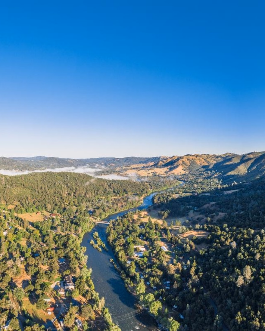 Panorama of wooded hills and river canyon