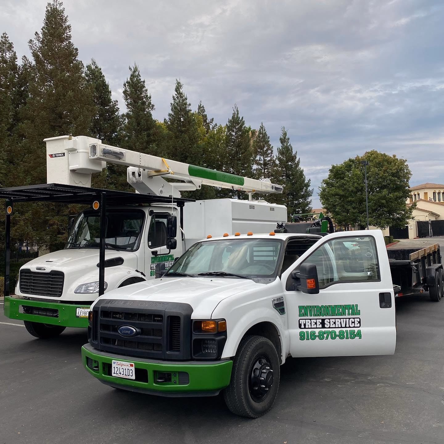 Environmental Tree Service: bucket truck and pickup parked at a job