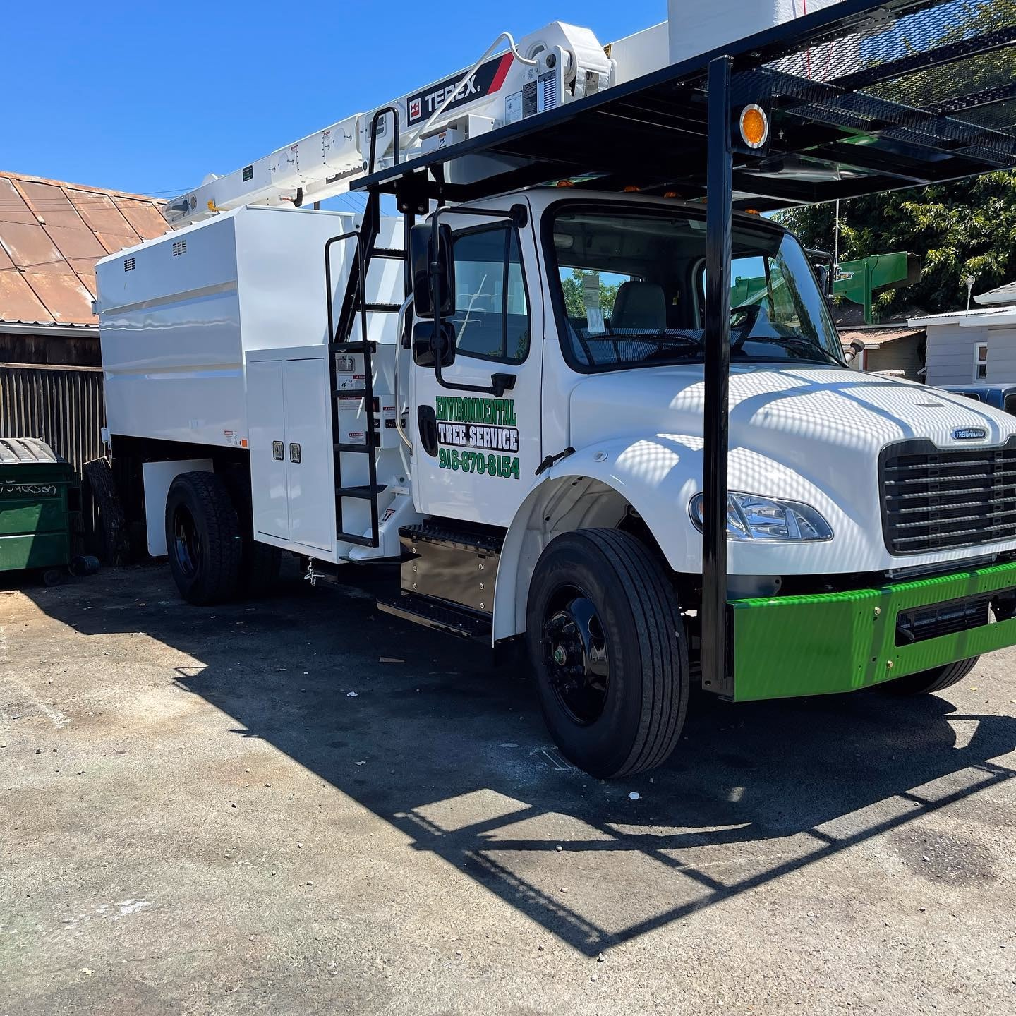Environmental Tree Service: chip truck and bucket truck ready for a job