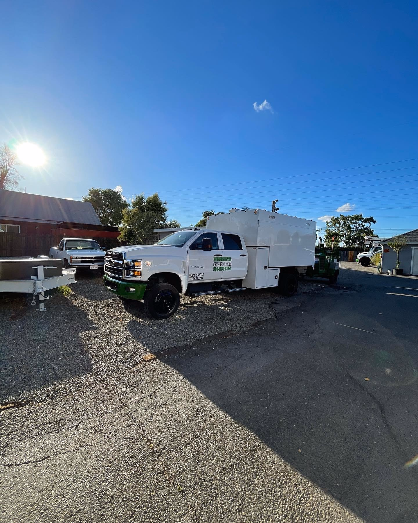 Environmental Tree Service: white chip truck parked on a residential street